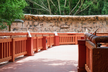 Pathway orange bridge in forest,Beautiful pathway in the sunshine with flower garden,Wood path in In Spring Deep Forest,national park,Deep forest pathway,space for text..