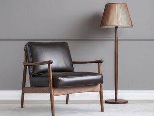 Fototapeta premium Stylish leather chair with modern lamp against a gray wall.