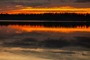 Fototapeta premium Marvelous and Stunning Sunset Reflection Over Serene and Calm Waters of a Beautiful Lake
