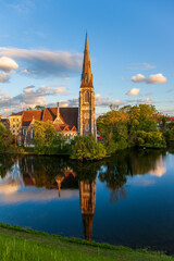Fototapeta premium There is a reflection of gothic church in water by the lake