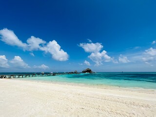 Fototapeta premium Long beach in resort under beautiful blue sky