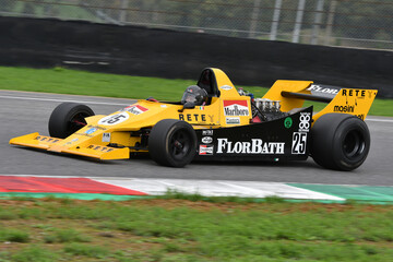 Fototapeta premium Scarperia, Italy - October 12th 2024: Merzario F1A3 of year 1979 drive by unknown in action during practice session at Mugello Circuit.