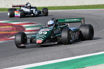 Fototapeta premium Scarperia, Italy - October 12th 2024: Tyrrell 011 of year 1982 ex Michele Alboreto drive by unknown in action during practice session at Mugello Circuit.