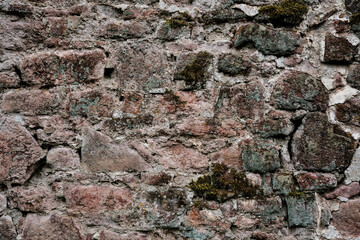 Fototapeta premium A wall made of stone with a rough texture. The wall is brown and white