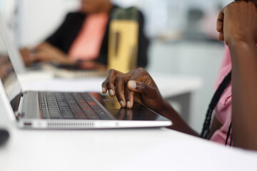 Office workers’ hands on computer, Accra, Ghana