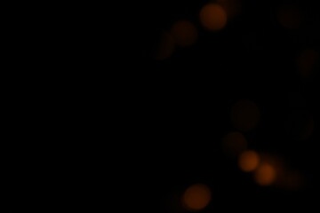 Red and fire orange bokeh on a black background, bokeh abstract background, modern abstract backdrop. Orange Christmas background, Xmas backdrop. Halloween scary concept, Halloween bokeh background
