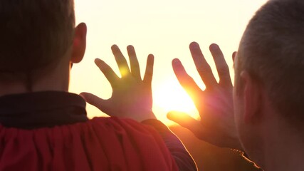 Superhero father and son sunset silhouette. Heroic moment father and son hand sunlight rays. moment mentoring fathers
