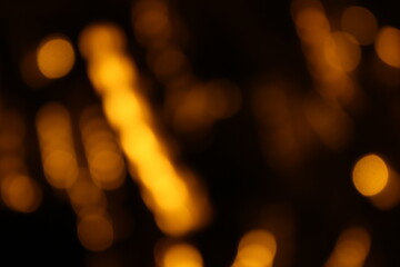 Fototapeta premium Red and fire orange bokeh on a black background, bokeh abstract background, modern abstract backdrop. Orange Christmas background, Xmas backdrop. Halloween scary concept, Halloween bokeh background 