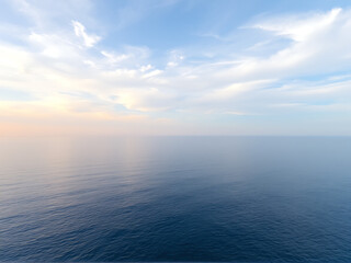 Obraz premium Aerial view of the ocean showcasing vibrant blue waters and gentle waves under a clear sky.