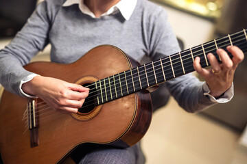 Obraz premium Mature Woman Playing Guitar At Home
