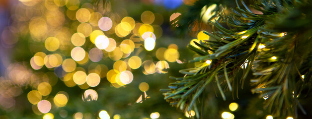 Christmas texture for postcards. Christmas garlands and fir branches. Garland with lights on the...