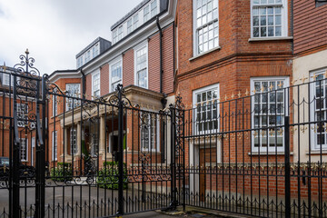 Red bricks houses on Hans Crescent street in Royal Borough of Kensington and Chelsea, London, UK
