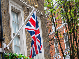 National flag of the United Kingdom is the Union Jack, also known as the Union Flag on houses in central London, UK