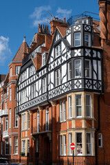 Obraz premium Red bricks houses on Hans Crescent street in Royal Borough of Kensington and Chelsea, London, UK