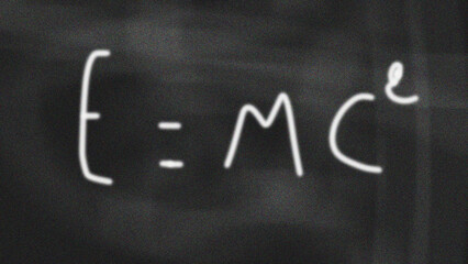 Relativity equation E=mc2 handwritten on blackboard