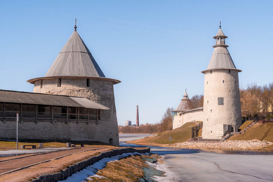The Pskov Krom (Kremlin), an ancient castle in the old city of Pskov, western Russia, with fortified tower, citadel walls, and frozen river ice.
