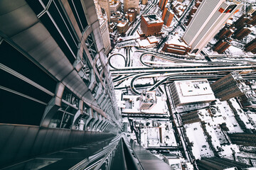 A snow covered New York City, rooftop look down in financial district, Manhattan during the day in...