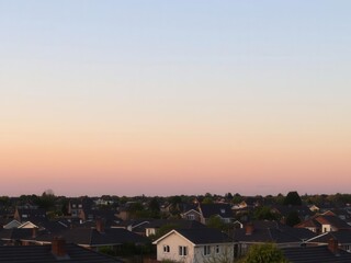 Golden light illuminating a calm suburban neighborhood at sunset, suburbia, neighborhoods