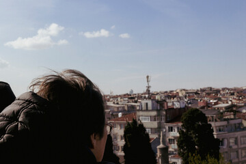 Woman looking out at the cityscape on a sunny day in istanbul, turkey