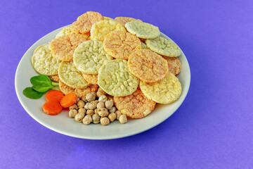 Chickpea chips snack with vegetables on a plate