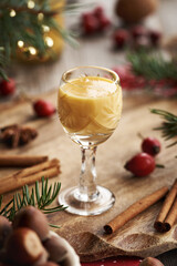 Obraz premium Two shot glasses of Eiercognac with spices and Christmas decoration