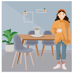 A girl with a cup of coffee stands in the room
