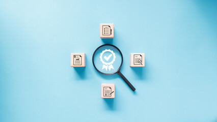 A magnifying glass is placed over certificate icon surround by set of wooden blocks with document verification icon in concept of examine and analyze document for quality control.