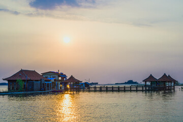 Obraz premium view of floating buildings with a sunset background in Pekalongan Mangrove Park