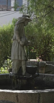 Huaraz, Ancash, Peru -  July 27 2024: Fountain in the Form of a Statue of a Peasant Woman Fetching Water with a Cantharus