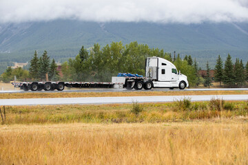 Heavy Cargo on the Road. A truck hauling freight along a highway. Taken in Alberta, Canada