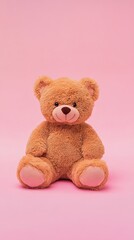 Obraz premium Adorable Brown Teddy Bear Sitting on Pink Background
