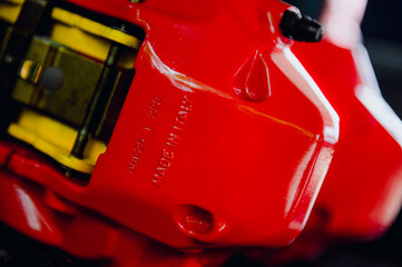 Big red brake caliper.Large brake calipers for effective braking.Car wheel and brake system.Red...