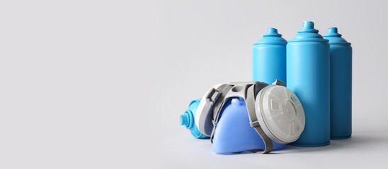 Respirator and spray cans on grey background with space for text