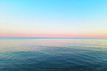 beautiful gentle sunset in pink, blue and turquoise tones on the sea or ocean
