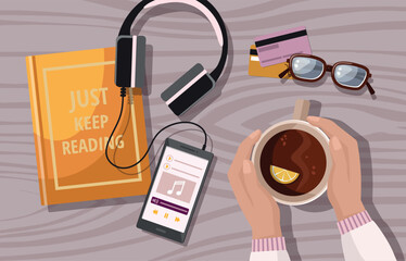 Book, coffee, mobile phone and earphones, on wooden table, flat lay.