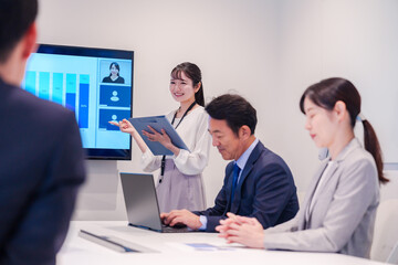 Fototapeta premium 会議室でプレゼンをする若い女性