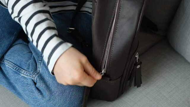 Slow Fastening Of Leather Backpack Metal Zipper, Zipper Binding. Stuck zipper. The zipper is catching.