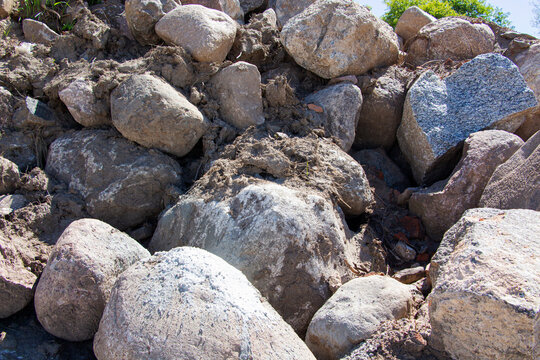 A large, uneven pile of rocks is precariously sitting on top of each other