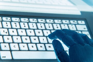 Robot hands focus on a laptop button, representing the seamless operation of an advisor chatbot within the realm of artificial intelligence.