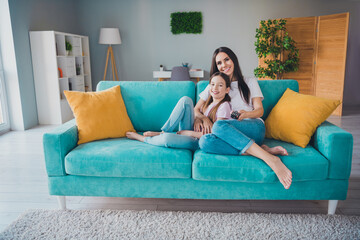 Photo of happy family cute mom and daughter enjoy weekend time together watch movie indoors living room