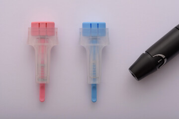 blue and pink disposable blood collection lancets in high resolution