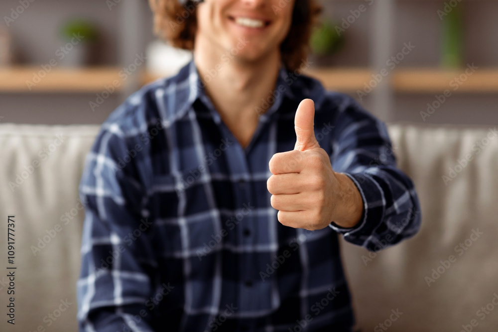 Poster i like it. unrecognizable guy gesturing thumbs up to camera approving something posing sitting on co