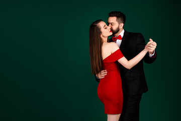 Photo of stunning young girl guy couple dancing kiss cheek wear trendy fancy classy outfit isolated on green color background