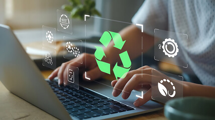 Naklejka premium a person typing on a laptop, with a digital overlay displaying a prominent green recycling symbol and several icons representing sustainability and environmental practices