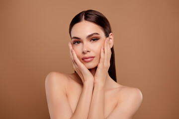 Photo of shiny adorable lady wear nothing arms apply skin lotion isolated brown color background