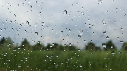 Raindrops on a window pane glass surface