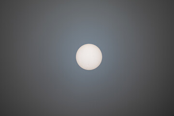 sunspots on the surface of the sun viewed through foggy atmosphere