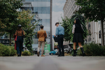 A group of business professionals walks together through a modern cityscape, exuding teamwork and connection. This image captures a moment of collaboration and urban lifestyle, surrounded by