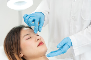 Naklejka premium plastic surgery, beauty, Surgeon or beautician touching woman face, surgical procedure that involve altering shape of nose, doctor examines patient nose before rhinoplasty, medical assistance, health