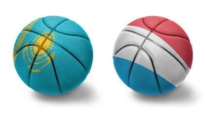 basketball balls with the national flags of luxembourg and kazakhstan on the white background.